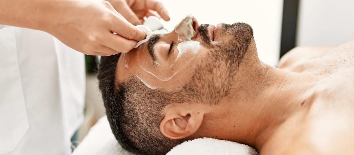 Man receiving a gentleman's facial treatment at spa